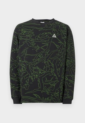 Bluză neagră cu mâneci lungi, cu modele abstracte verzi în linii și un logo mic ACG alb pe partea stângă a pieptului.