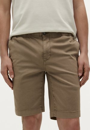 Shorts din bumbac bej cu o croială relaxată, talie elastică, buzunare laterale și tiv cusut. Închidere frontală cu detalii din butoane.