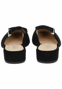 Black suede backless shoes with a low block heel, an adjustable strap, and a round toe design. Smooth interior and flat rubber sole.