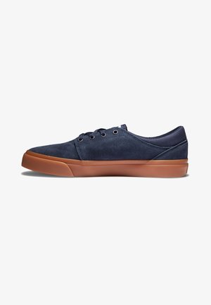 Navy suede sneakers with brown rubber soles, round toe, and six eyelet lace-up design. Smooth texture with subtle stitching details.