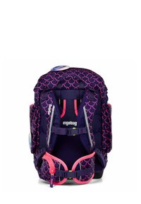 Purple backpack with pink scale pattern, adjustable straps, buckles, and reflective accents for visibility. Ergonomic design for comfort.