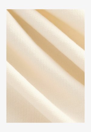 Cream-colored fabric, softly textured with a fine knit. The drapery shows gentle folds, highlighting its lightweight and smooth quality.