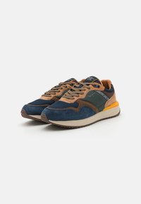 Navy and brown suede sneakers with mesh accents, featuring a beige midsole, rubber outsole, and vibrant yellow details on the heel.