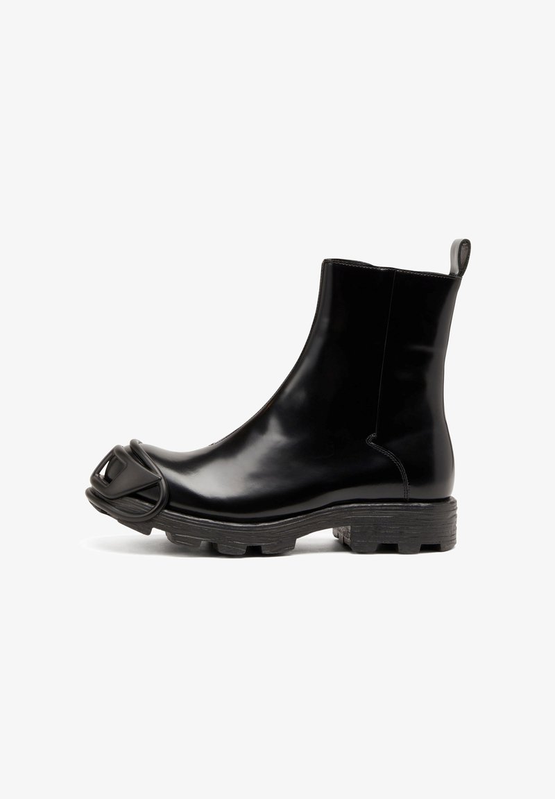 Black rubber ankle boot with a glossy finish, feature a rounded toe and a distinctive, sculpted accent on the toe. Textured black sole.