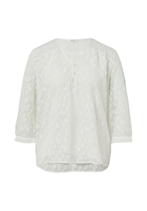Blusa bianca in tessuto leggero con un motivo testurizzato. Caratterizzata da un collo a V, maniche a tre quarti e un delicato dettaglio a bottoni.
