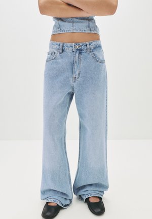 Light blue wide-leg jeans with a high waist, made from denim with a speckled texture, featuring a button closure and side pockets.