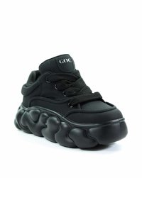 Czarne sneakersy z masywną, falistą podeszwą. Wykonane z gładkiego materiału, wyposażone w wyściełany język, grube sznurówki i subtelne logo na kostce.