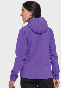 Lila wasserdichte Jacke mit einer strukturierten Kapuze, elastischen Bündchen und einer glatten Textur. Hat dezente Markenkennzeichnung am Ärmel.