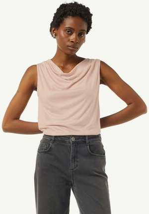 Sleeveless top in soft pink fabric with draped neckline. Paired with dark grey denim pants featuring front pockets and a button closure.