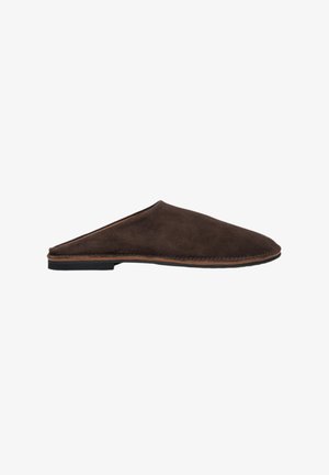 Brown suede slip-on mules with a rounded toe, low flat black sole, and stitched accents along the edge. Minimalist design and soft texture.