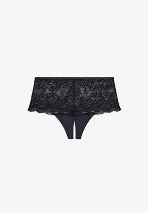 Culotte en dentelle noire avec un matériaux doux, des motifs floraux complexes et un design sans couture, agrémentée de bordures en dentelle.