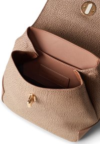 Tan leather handbag with a textured, pebbled exterior, gold hardware, and an open top revealing a smooth, light-colored interior.