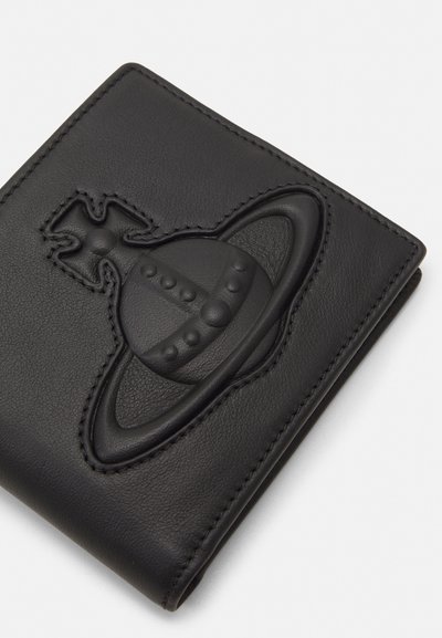 Black leather wallet featuring a 3D embossed design of a planet with rings and a cross symbol, outlined with precise stitching.