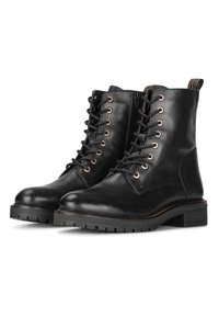 Botas cortas de cuero negro con cordones en la parte delantera, ojales de metal y cremallera lateral. Presenta una suela texturizada y un ligero tacón cuadrado.