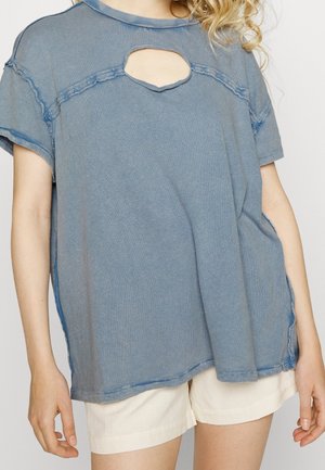 Blaues, oversized T-Shirt mit einem Front-Schlitz, rohen Saumkanten und kurzen Ärmeln, aus weichem, strukturiertem Stoff gefertigt.