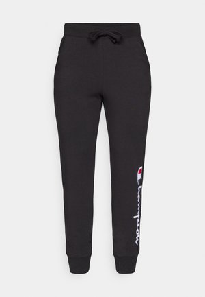 Pantaloni de trening negri, dintr-un material moale, având un talie cu șnur și manșete cu nervuri, cu un logo alb și roșu "Champion" pe lateral.