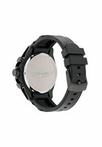 Černé chronografové hodinky s texturovaným gumovým páskem. Disponují stříbrným zadním víčkem s logem. Na boku se nachází tlačítka a korunka.