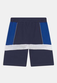 Calções de marinheiro com detalhes em azul e branco; cintura elástica, corte reto e painéis laterais contrastantes. Tecido suave e liso.