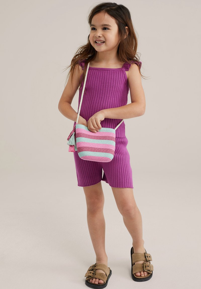 Purple ribbed romper with ruffled straps, paired with a small striped bag in pink and teal. The child wears brown buckled sandals.