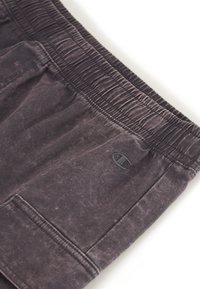 Dunkelgraue Sweatpants mit strukturiertem Stoff und elastischem Bund. Enthält Seitentaschen und ein dezentes stickiertes Logo.