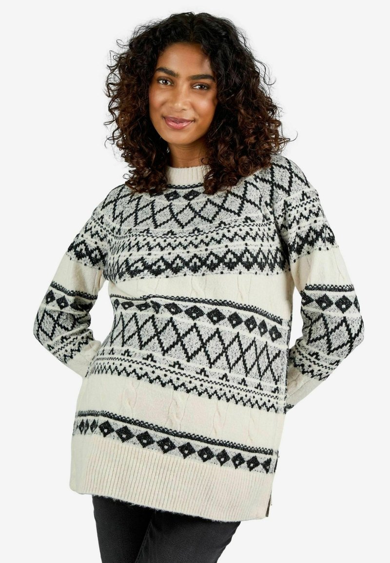Gebreide trui in crème met zwarte geometrische patronen, voorzien van een geribde zoom en zijopeningen voor extra comfort. Lange mouwen.