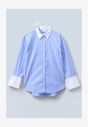 Svijetloplena pruga koja se proteže na dugim rukavima s bijelim ovratnikom, prednjim kopčanjem, lijevim džepom na prsima i širokim bijelim manžetama. Mekana tekstura tkanine.