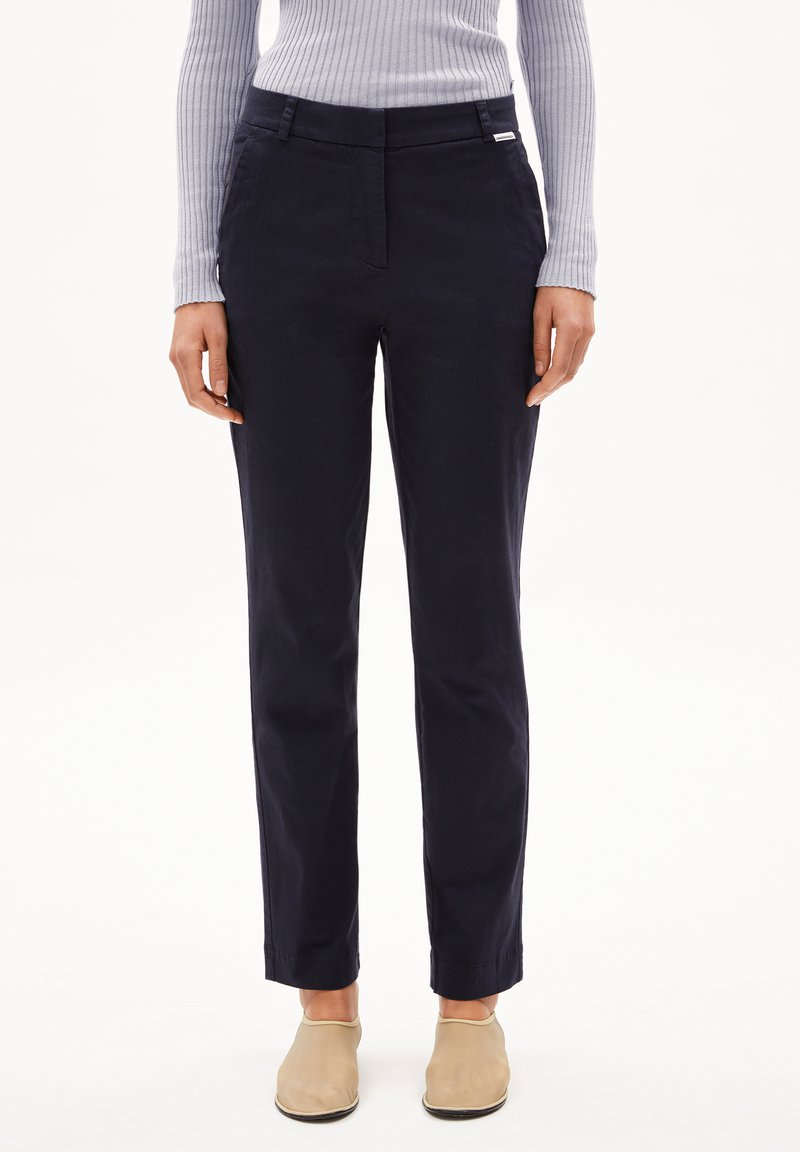 Marineblauwe broek met een rechte snit, voorzien van een platte voorkant, ceintuurlussen en een klein label op de tailleband. Gemaakt van een lichtgewicht stof.