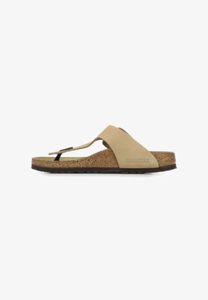 Lichtbeige slipper sandalen met een kurken voetbed, verstelbare band en rubberen buitenzool. Heeft een minimalistisch ontwerp zonder versieringen.