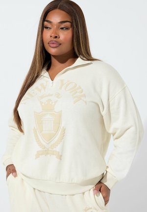 Elfenbeinfarbener Reißverschluss-Hoodie mit dem Schriftzug "NEW YORK" und Emblem in hellerer Farbe. Aus weichem Material, mit lockerer Passform und Seitentaschen.