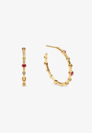 Zlaté kruhové náušnice mají segmentovaný design s střídajícími se malými barevnými drahokamy, včetně červených, žlutých a modrých akcentů.