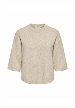 Beež lühikeste varrukatega kudum, millel on ümmargune kaelus ja lõdvestunud istuvus, valmistatud pehmest tekstuuriga kangast.