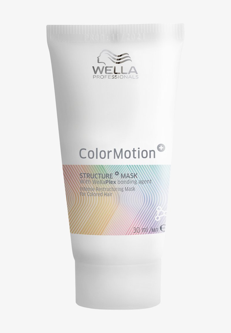 Vit tub med en genomskinlig kork som har en holografisk gradientdesign. Texten inkluderar "Wella Professionals," "ColorMotion," och produktdetaljer.