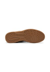 Sola de ténis Reebok com um exterior de borracha castanha, apresentando um padrão de aderência texturizado e o logótipo da Reebok em destaque.