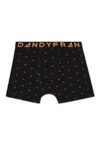 Svarta boxerkalsonger med ett upprepat mönster av guldstjärnor. Midjebandet är märkt "DANDYFRAN" i fet, versal stil.