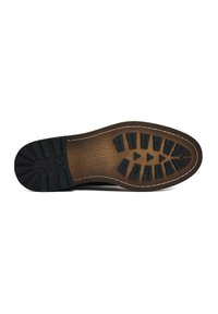 Black rubber sole with raised traction patterns and brown leather detailing. Features a stitched edge and embossed text on the arch area.