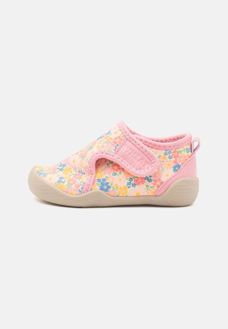 Floral slip-on shoe with a pink canvas upper featuring multicolored flowers, a textured beige rubber sole, and a Velcro strap for closure.