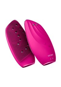 Dispositif de beauté rose à double face avec une surface en silicone texturée, dotée de points arrondis et de bords lisses, marqué de boutons de contrôle et de lumières LED.