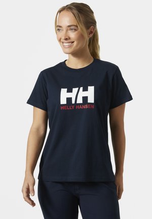 Camiseta de algodón azul marino con un logo blanco "HH" y la leyenda roja "HELLY HANSEN" debajo. Manga corta y corte relajado.