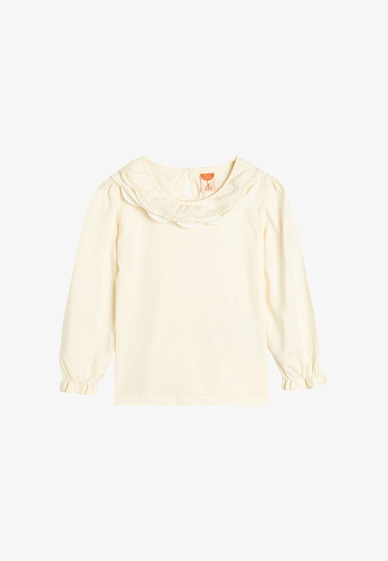 Chemise crème à manches longues avec un col volanté orné de dentelle. Manches bouffantes avec des poignets élastiques, fabriquée en coton doux.
