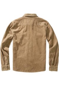 Camicia di velluto a coste in un color tan smorzato, con colletto a punta, maniche lunghe e una distintiva trama a costine verticali.