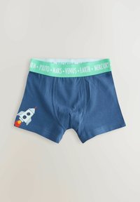 Marineblaue Boxershorts mit einem Raketenmotiv auf dem linken Bein; verfügen über einen hellgrünen Bund, auf dem die Namen von Planeten rundherum aufgedruckt sind.