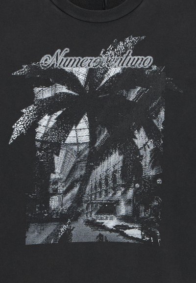 Black cotton t-shirt featuring a graphic of a palm tree over a cityscape, with the text "Numeri Uno" in a stylized font above the image.