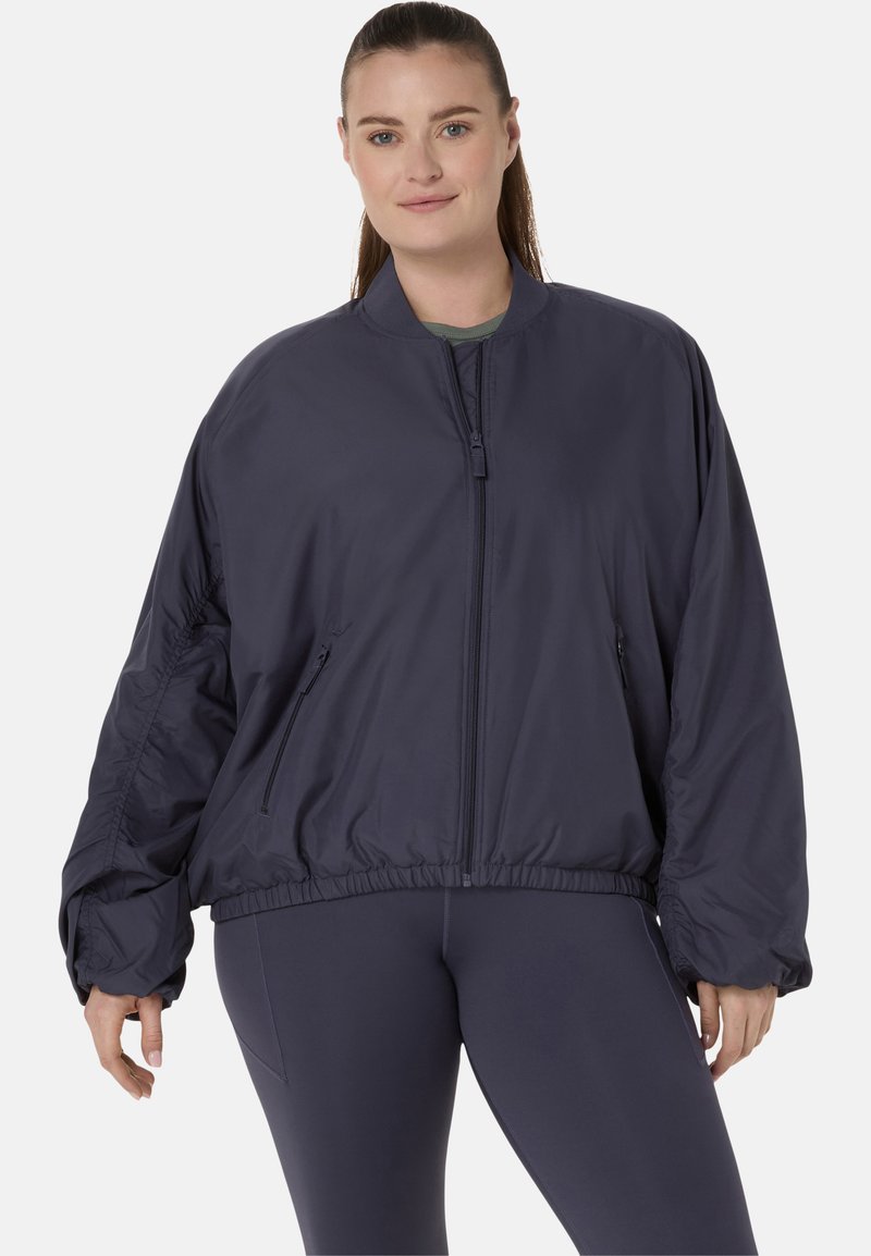 Veste de bombardier navy avec fermeture éclair à l'avant, taille élastique et deux poches latérales. Elle présente une coupe décontractée et un tissu léger.