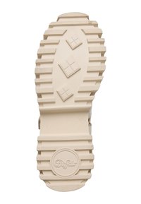Semelle de chaussure beige avec des crampons profonds, trois motifs carrés au centre, logo circulaire "Buffalo" près du talon, et taille 38.