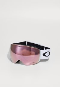 Rosa tippede skibriller med en stor buet linse, sort og hvid elastisk rem og sølvdetaljer; merkenavnet "Oakley" synlig.