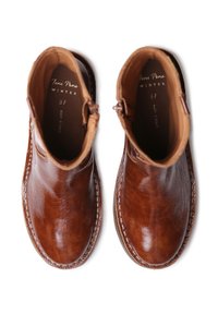 Brown leather ankle boots with a smooth texture, rounded toe, side zippers, and contrasting stitching along the sole. Labeled interior.