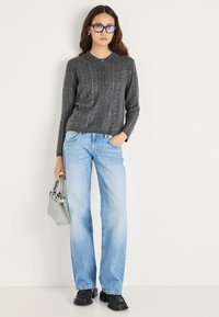 Cárdigan gris de punto acanalado con cuello y botones en la parte delantera; jeans de pierna ancha azul claro; botines negros; bolso gris.