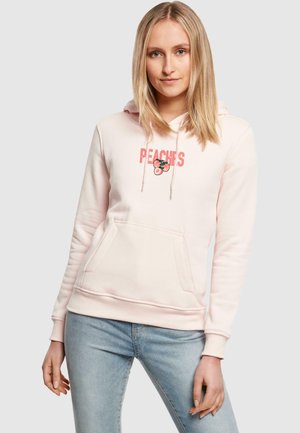 Ljusrosa hoodie med "PEACHES" grafik och persikoillustration. Har en framficka, snören och ribbade ärmslut och nederkant. Mjuk textur.