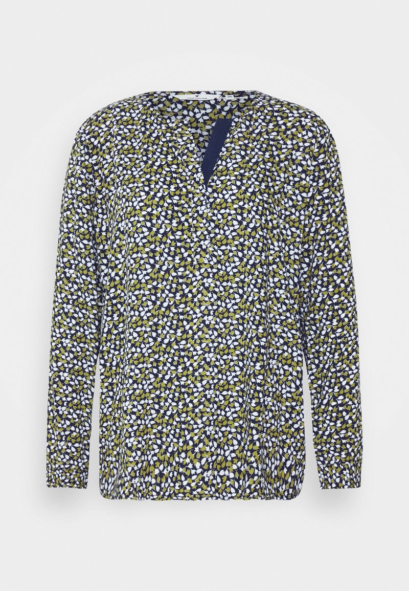 Blusa a maniche lunghe in blu navy, con un motivo floreale in bianco e verde. Collo rotondo con un piccolo dettaglio a chiave.