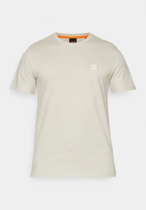 Short-sleeve T-shirt in light beige cotton, featuring a small square logo on the chest and an orange accent on the neck collar.